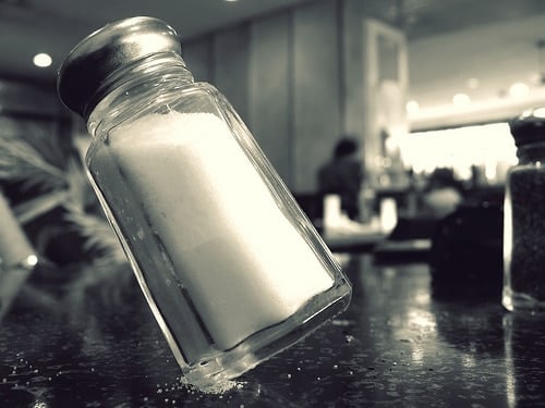A salt shaker, precariously balanced at a 30-degree angle.