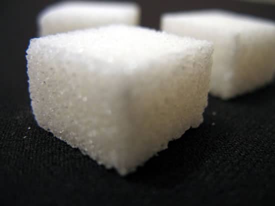 A closeup of a sugar cube, in three-quarters perspective.