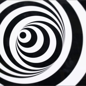 A black and white spiraling optical illusion, giving the sensation of vertigo.