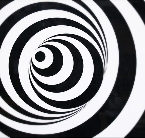 A black and white spiraling optical illusion, giving the sensation of vertigo.
