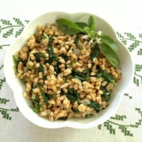 Overhead view of a bowl of farro with spinach.