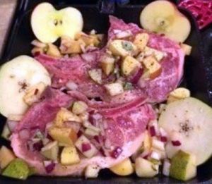 pork chops and fruit, ready to be roasted