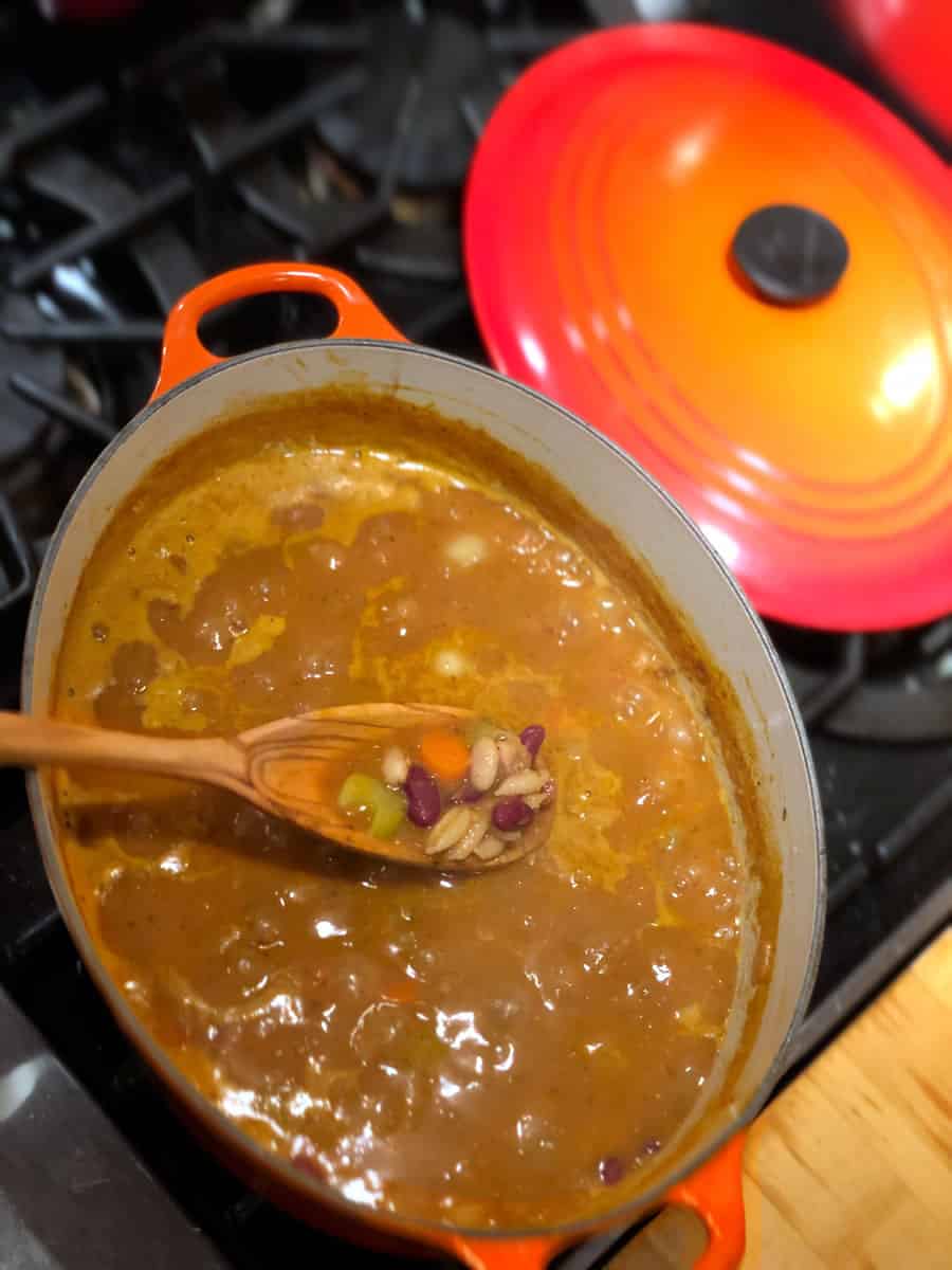 Overview view of a pot of minestrone soup, simmering on the stove