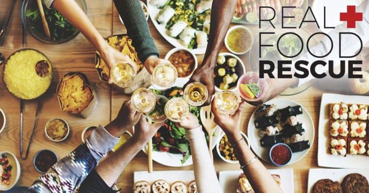 Friends toasting over a full banquet table of food